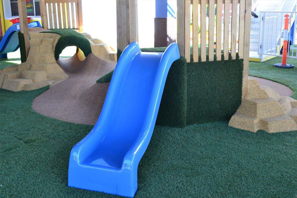 Blue Slide With Artificial Surface Grass