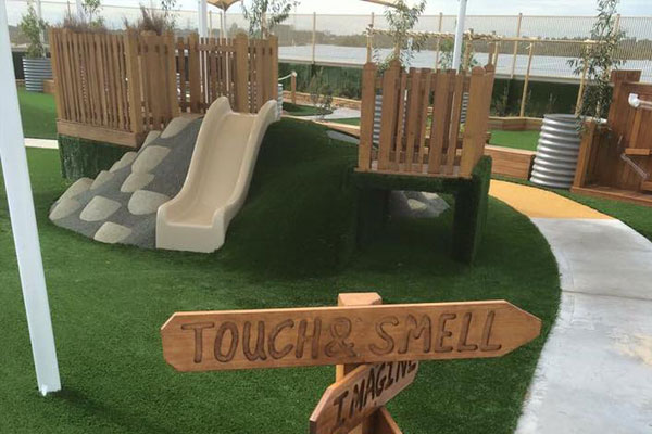 Slide With Wood Fence Synthetic Floor Grass - Little Learning School In Caringbah